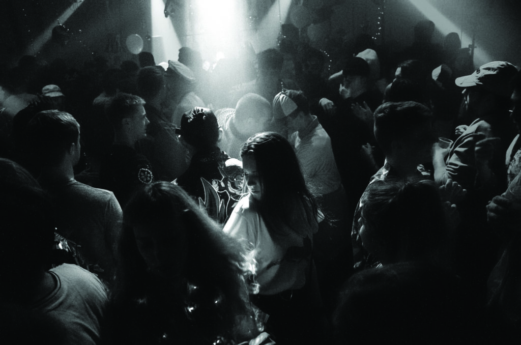 black and white picture of a crowd of people in a club